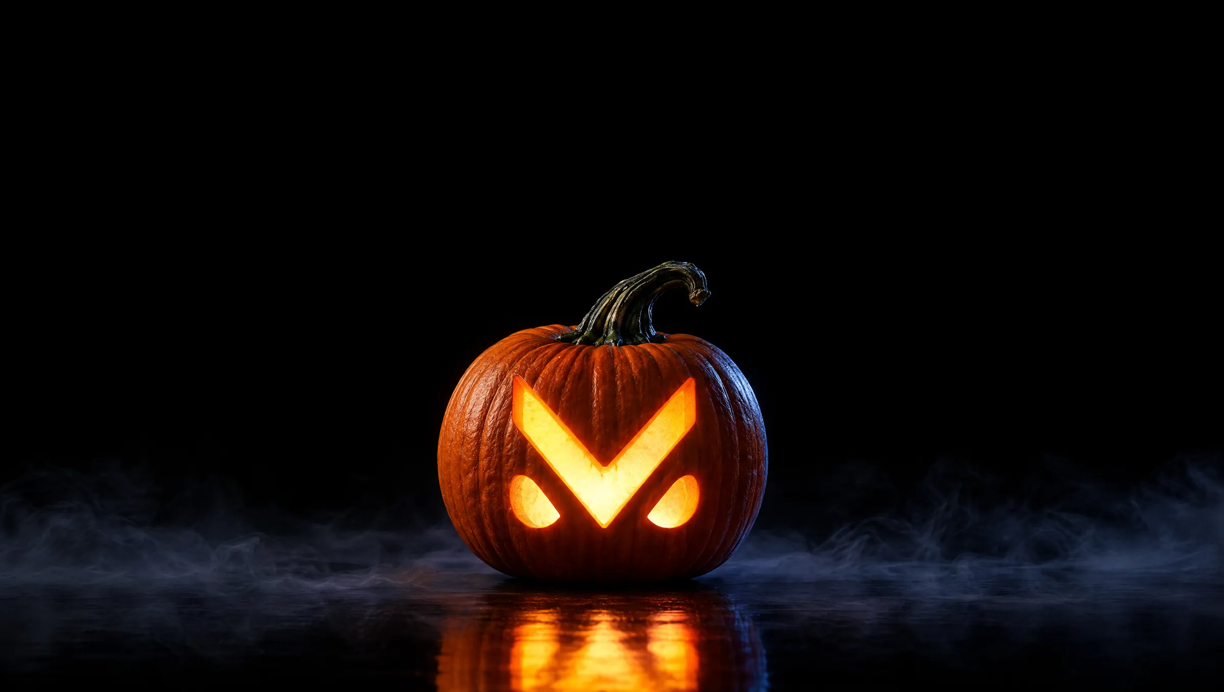 A pumpkin carved with the Mad Labs M, lit from inside